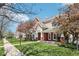 Exterior view of townhomes with brick facades, covered porches, landscaped lawns, and a sidewalk at 720 Bucksport Ln, Westfield, IN 46074
