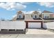 Attached two-car garage with white door complemented by brick and siding exterior at 720 Bucksport Ln, Westfield, IN 46074
