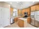 Kitchen featuring stainless steel appliances, light wood cabinetry, and a door to the outside at 720 Bucksport Ln, Westfield, IN 46074