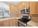 Kitchen featuring stainless steel appliances, light wood cabinetry and stone backsplash at 720 Bucksport Ln, Westfield, IN 46074