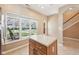 Kitchen featuring an island, views of backyard and staircase with lots of natural light at 720 Bucksport Ln, Westfield, IN 46074