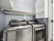 Modern stainless steel washer and dryer set in a bright laundry room with shelving at 720 Bucksport Ln, Westfield, IN 46074