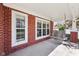 Inviting porch with brick accents, windows, and a relaxing wooden porch swing at 720 Bucksport Ln, Westfield, IN 46074