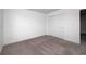 Bedroom with light gray carpet and white sliding closet doors for a clean, modern look at 7265 Governors Row, Avon, IN 46123