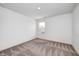 This is a simple bedroom with neutral carpet and a window overlooking the neighborhood at 7265 Governors Row, Avon, IN 46123
