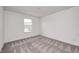 Neutral bedroom with gray carpet and a double-hung window looking out over the front yard at 7265 Governors Row, Avon, IN 46123