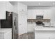 Stylish kitchen with stainless steel appliances, white cabinetry, and a functional island with counter seating at 7265 Governors Row, Avon, IN 46123