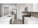 Well-designed kitchen featuring white cabinets, stainless steel appliances, and an island with a sink at 7265 Governors Row, Avon, IN 46123