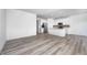 Open-concept living and kitchen area with modern appliances, white cabinets, and stylish flooring at 7265 Governors Row, Avon, IN 46123