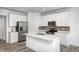 Bright kitchen featuring white cabinets, stainless steel appliances, an island, and modern countertops at 7265 Governors Row, Avon, IN 46123