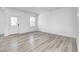Bright living room featuring light wood floors, a large window, and neutral walls, creating a modern space at 7265 Governors Row, Avon, IN 46123