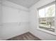 This simple walk-in closet features wire shelving and a window with a beautiful view at 7265 Governors Row, Avon, IN 46123