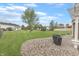 Spacious backyard featuring a well-maintained lawn, a charming patio area, and mature trees, perfect for outdoor enjoyment at 7860 Sergi Canyon Dr, Indianapolis, IN 46217
