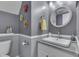 Stylish bathroom with modern vanity, round mirror, and attractive gray wall decor at 7860 Sergi Canyon Dr, Indianapolis, IN 46217