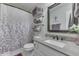 Well-appointed bathroom with granite vanity, mirror, and shower with patterned curtain at 7860 Sergi Canyon Dr, Indianapolis, IN 46217
