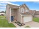 Charming two-story home featuring brick and siding, a two-car garage, and a well-manicured lawn at 7860 Sergi Canyon Dr, Indianapolis, IN 46217