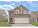 Charming two-story home featuring brick and siding, a two-car garage, and a well-manicured lawn at 7860 Sergi Canyon Dr, Indianapolis, IN 46217