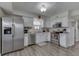 Well-lit kitchen featuring stainless steel appliances, a sink and white cabinets at 7860 Sergi Canyon Dr, Indianapolis, IN 46217