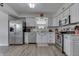 Well-lit kitchen with white cabinetry, stainless steel appliances, and wood-look flooring at 7860 Sergi Canyon Dr, Indianapolis, IN 46217