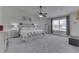 Spacious bedroom with large window, ceiling fan, and carpeted floor at 7860 Sergi Canyon Dr, Indianapolis, IN 46217