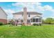 Large backyard featuring a patio area, well-maintained lawn, and partial view of screened-in porch at 8181 Fairway Dr, Brownsburg, IN 46112