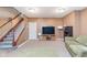 Finished basement with carpet, a comfortable seating area, and access to the staircase at 8181 Fairway Dr, Brownsburg, IN 46112