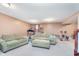 Inviting basement area with comfortable sofas, perfect for relaxing or entertaining guests in a casual setting at 8181 Fairway Dr, Brownsburg, IN 46112