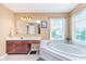 Bright bathroom with a large tub, vanity area, and abundant natural light, offering a tranquil retreat at 8181 Fairway Dr, Brownsburg, IN 46112