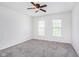 Clean and bright bedroom with two windows offering natural light, and neutral-colored walls at 8181 Fairway Dr, Brownsburg, IN 46112