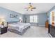 Spacious primary bedroom with a ceiling fan, large window, and neutral carpet at 8181 Fairway Dr, Brownsburg, IN 46112