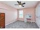 This bedroom features a ceiling fan, a window, and a built-in desk, perfect for studying or working at 8181 Fairway Dr, Brownsburg, IN 46112