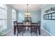 Bright dining room with neutral walls, modern lighting, and arched window at 8181 Fairway Dr, Brownsburg, IN 46112