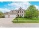 Charming two-story home featuring a brick facade, manicured lawn, and three-car garage at 8181 Fairway Dr, Brownsburg, IN 46112
