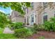 Inviting entryway featuring a decorative front door, manicured shrubs, and beautiful landscaping at 8181 Fairway Dr, Brownsburg, IN 46112