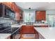 Modern kitchen featuring updated appliances, quartz counters, and wood cabinets at 8181 Fairway Dr, Brownsburg, IN 46112