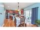 Spacious eat-in kitchen with stainless steel appliances, wooden cabinetry, and hardwood floors at 8181 Fairway Dr, Brownsburg, IN 46112