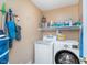 Functional laundry room equipped with a washer, dryer, and shelving for storage at 8181 Fairway Dr, Brownsburg, IN 46112