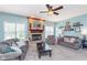 Comfortable living room with a brick fireplace, ceiling fan, and neutral-toned furnishings at 8181 Fairway Dr, Brownsburg, IN 46112