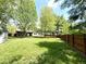 Large backyard with mature trees, fenced perimeter, and a small shed for outdoor storage at 8218 San Carlos Ct, Indianapolis, IN 46256