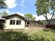 Wide backyard with lush green grass, spacious deck and mature trees at 8218 San Carlos Ct, Indianapolis, IN 46256