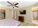 This bedroom has a ceiling fan, a dresser, and access to a bathroom at 8218 San Carlos Ct, Indianapolis, IN 46256