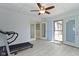 Bright bonus room with a ceiling fan, tile floors, and multiple entry/exit doors at 8218 San Carlos Ct, Indianapolis, IN 46256