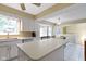 Open-concept kitchen features ample counter space, an island, and views of the dining area at 8218 San Carlos Ct, Indianapolis, IN 46256
