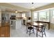 A white kitchen with stainless steel appliances, center island and adjacent eat-in breakfast nook at 8218 San Carlos Ct, Indianapolis, IN 46256
