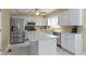 Spacious kitchen featuring stainless steel appliances, a center island, and bright white cabinetry at 8218 San Carlos Ct, Indianapolis, IN 46256