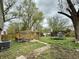Large backyard with pergola, trampoline and mature trees on an overcast day at 8231 Trevellian Way, Indianapolis, IN 46217