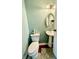 Quaint half bathroom featuring a pedestal sink and ample natural light at 8231 Trevellian Way, Indianapolis, IN 46217