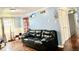 Open-concept living area with dark leather sofa and hardwood floors at 8231 Trevellian Way, Indianapolis, IN 46217