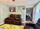 Comfortable living room featuring a plush, reclining leather sofa and cheerful decor at 8231 Trevellian Way, Indianapolis, IN 46217