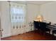 An office space in a room with hardwood floors and a musical instrument at 8231 Trevellian Way, Indianapolis, IN 46217